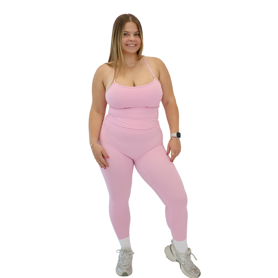 Woman wearing CONTOUR Pocket Leggings in Fairy Floss with a matching top
