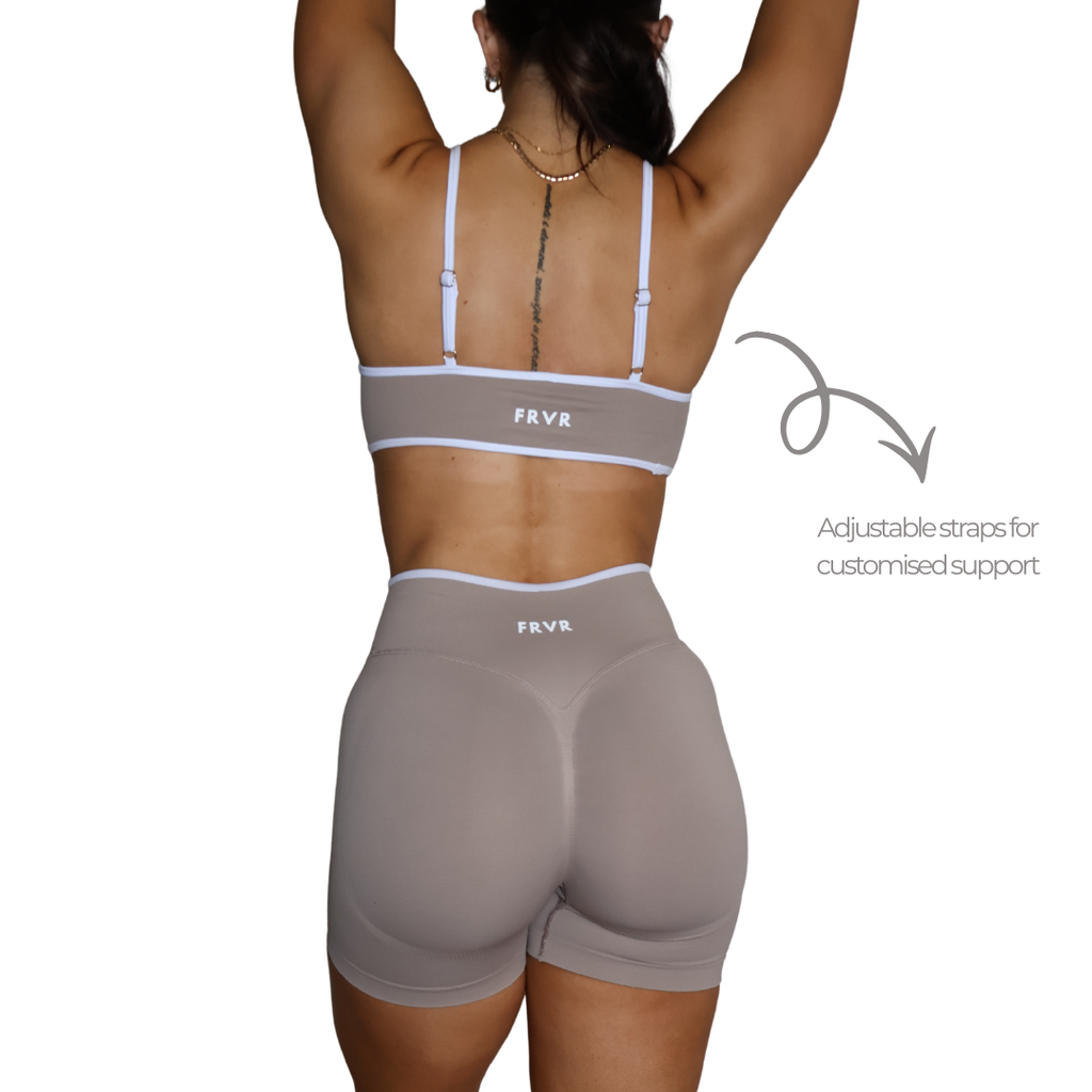 Womens beige sports bra with adjustable straps.