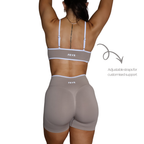 Womens beige sports bra with adjustable straps.